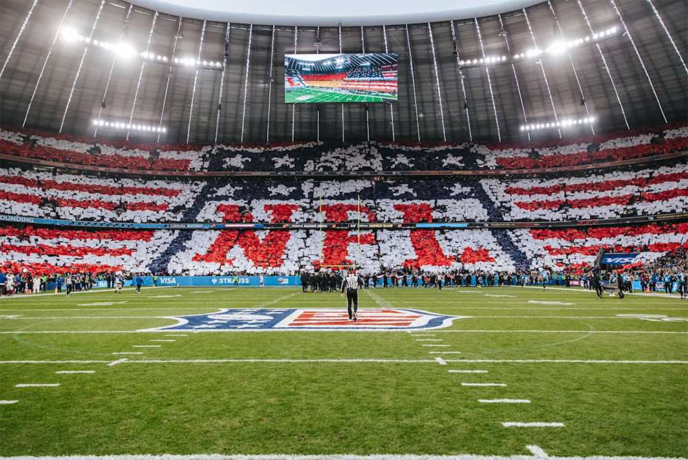 View of the stands from the field at Bank of America Stadium, Charlotte. The fans are holding up cards to create a giant NFL emblem.