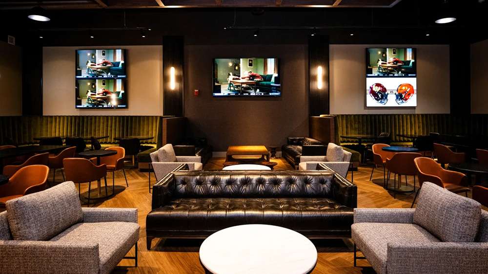 Lounge seating and HD screens in the Servpro Field Club at Huntington Bank Field, Cleveland.