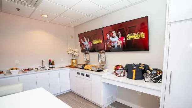 Refreshments and HD screens inside a Commanders suite at Northwest Stadium, Landover.